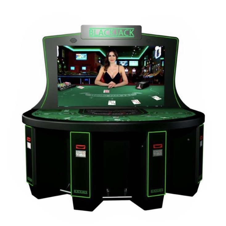 A green and black casino table with a man in the middle of it.